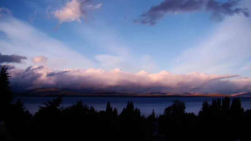 The wide blue waters of Lake Nahuel Huapi with mountains beyond