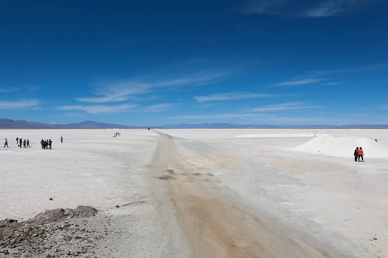 The vast white Salinas Grandes salt flat under a blue sky