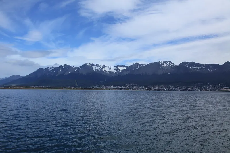 The town of Ushuaia beside the Beagle Channel with snow-capped mountains behind
