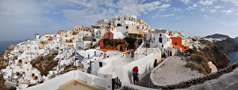 White-washed buildings and blue domes above the sea on a Mediterranean island