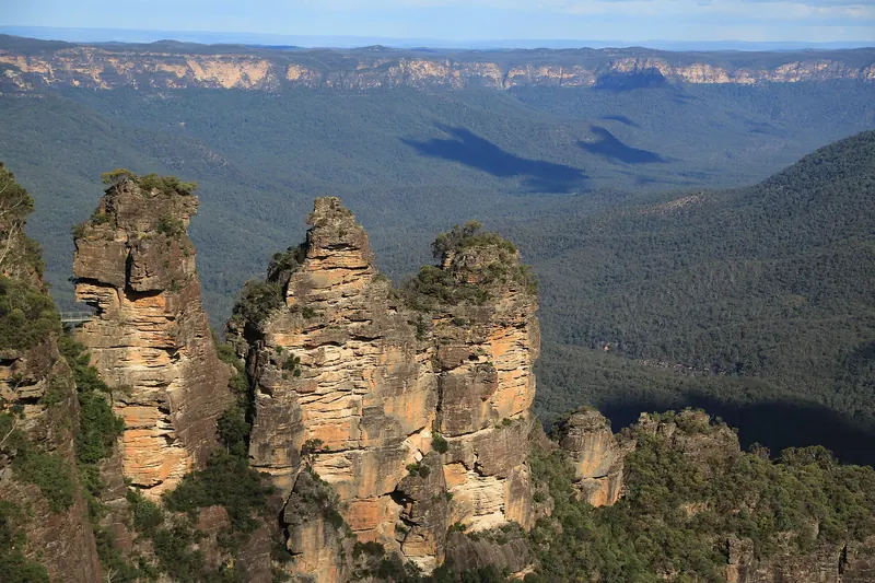 The Three Sisters rock formation above the forested Jamison Valley in the Blue Mountains