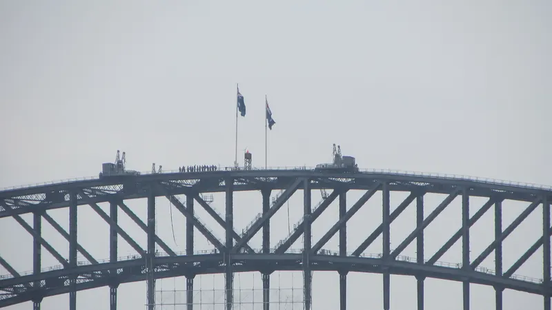 The steel arch of the Sydney Harbour Bridge over the water