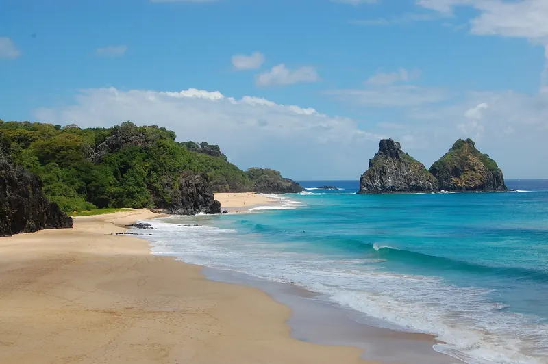 The twin rock peaks of Morro Dois Irmãos rising from the sea at Fernando de Noronha