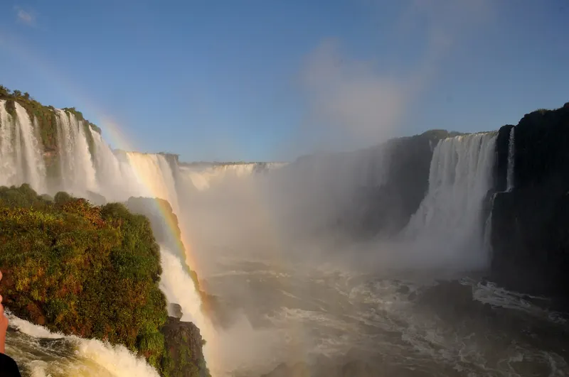 The Devil's Throat seen from the Brazilian side of Iguazu Falls, with a walkway and mist