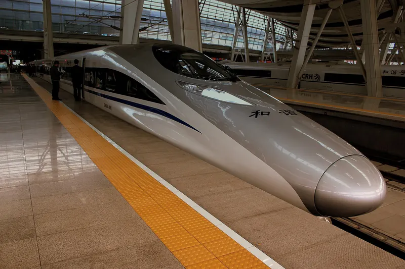 A white Chinese high-speed train (CRH380) at a platform