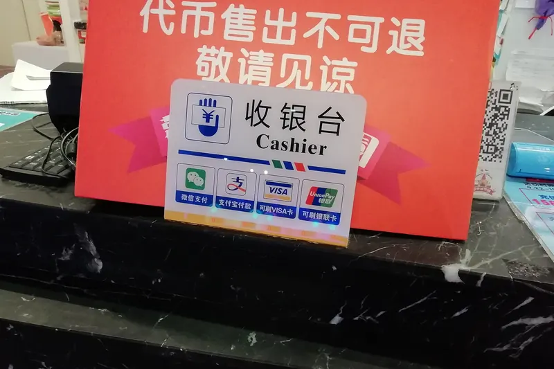 A shopfront sign showing that Alipay and WeChat Pay are both accepted