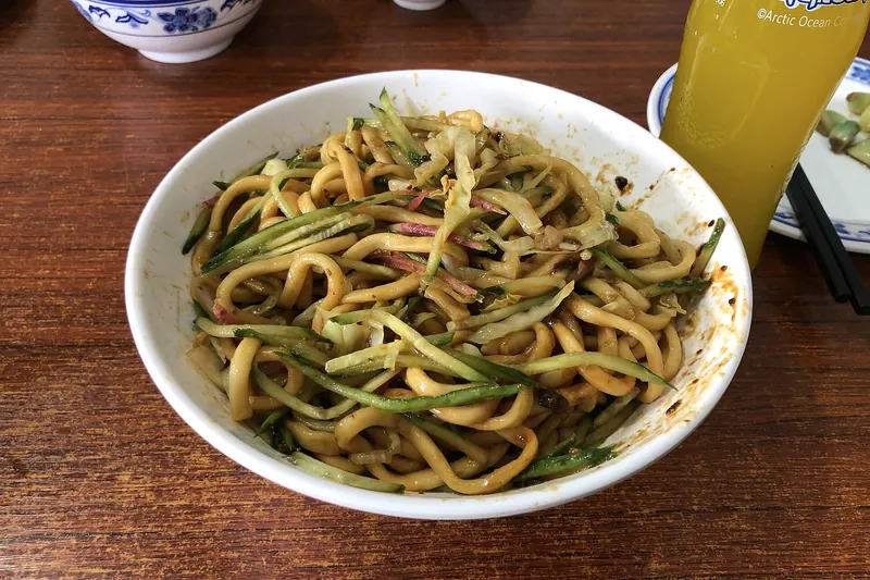 A bowl of zhajiangmian noodles stirred with fermented soybean sauce
