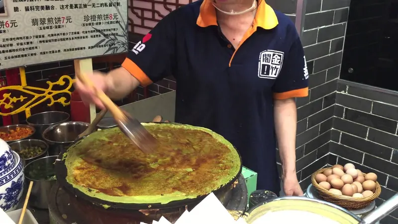 A folded jianbing savoury crepe with egg and crispy cracker inside