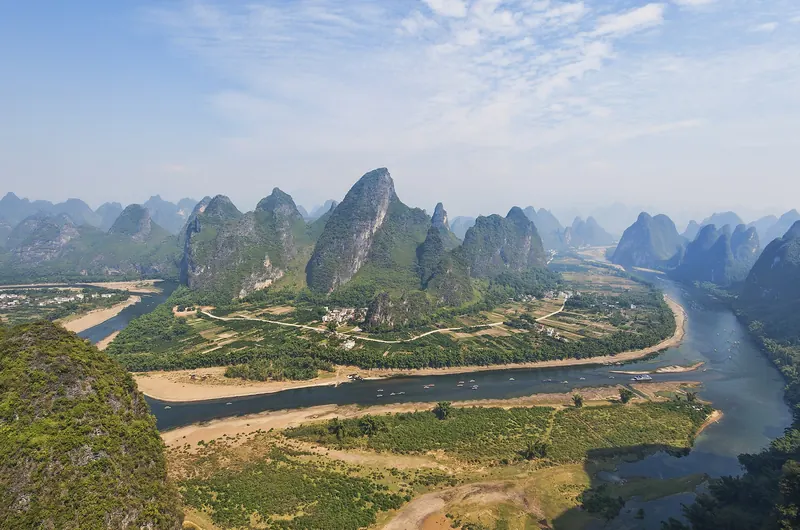 Limestone karst peaks reflected in the still water of the Li River
