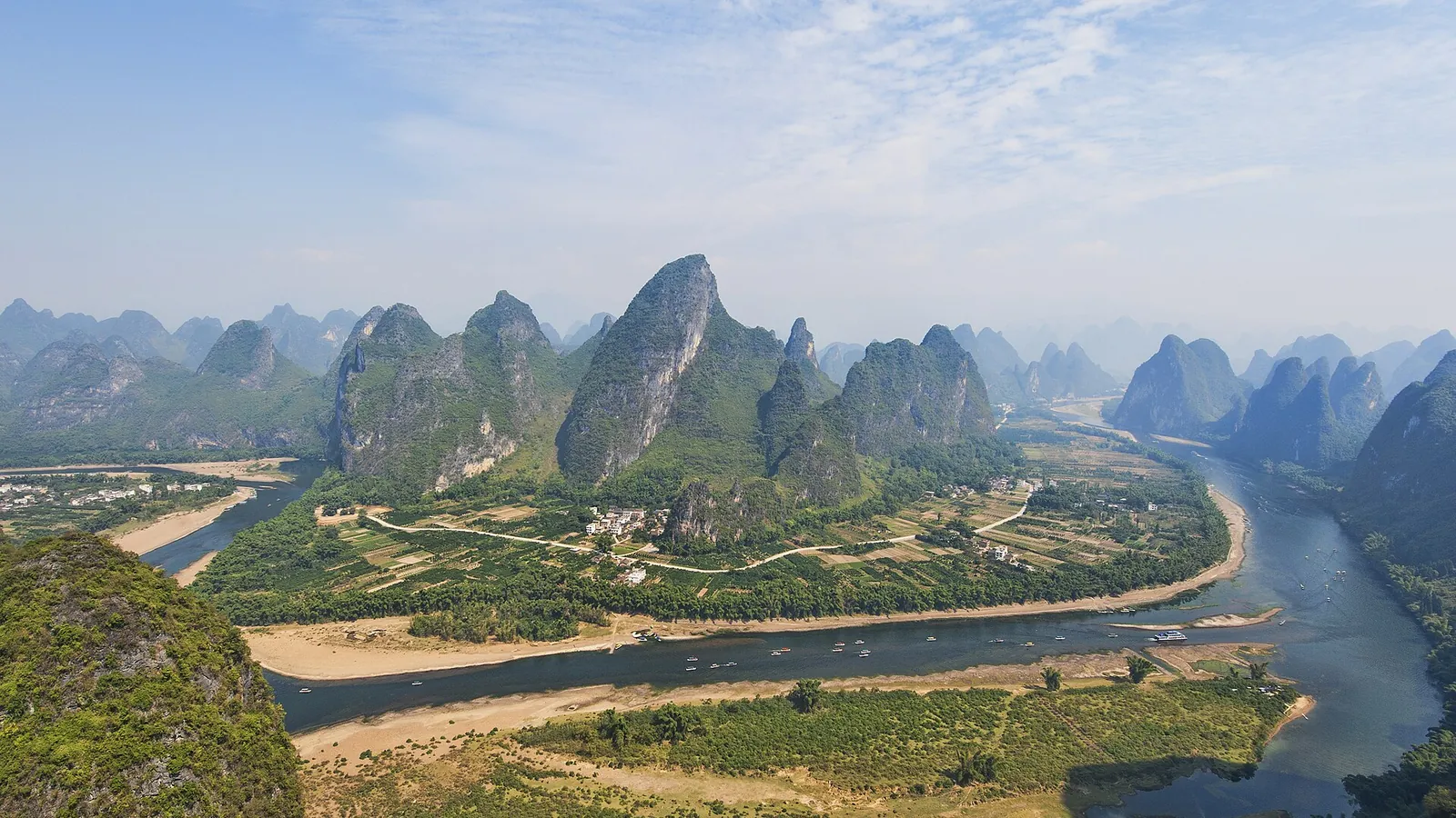 Limestone karst peaks reflected in the still water of the Li River