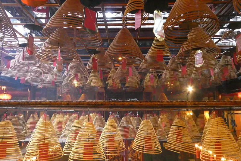 Large spiral incense coils hanging from the ceiling of Man Mo Temple
