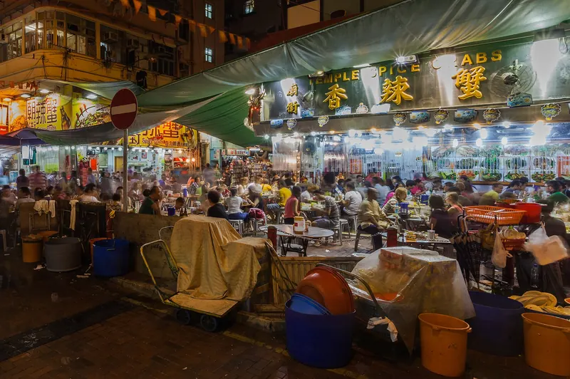 Stalls and crowds at Temple Street Night Market after dark