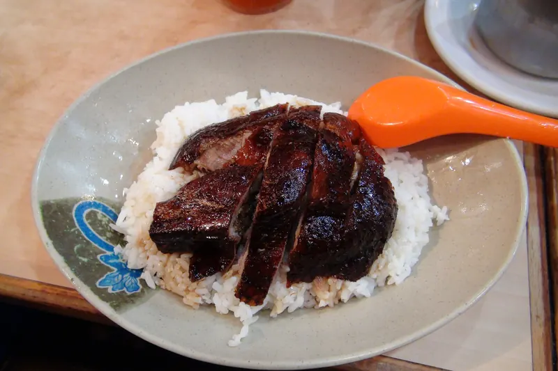 Glossy roast goose served over rice at Yat Lok