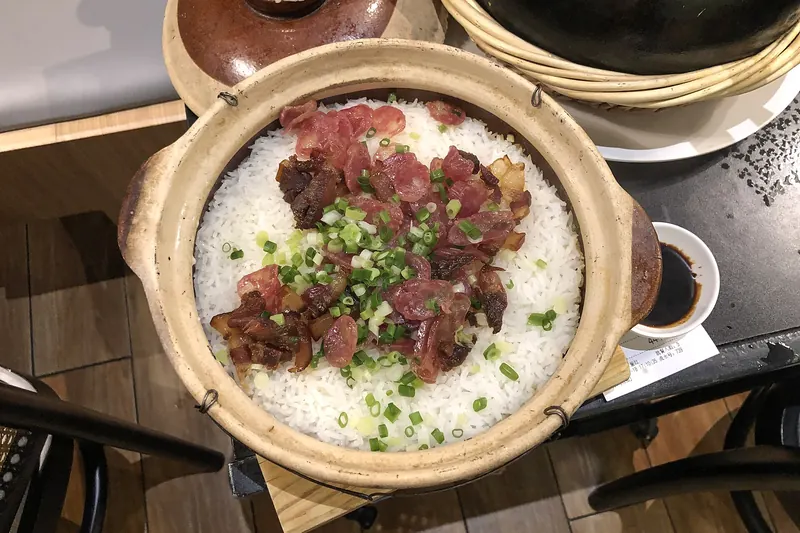 Claypot rice topped with cured meats and a crisp bottom layer