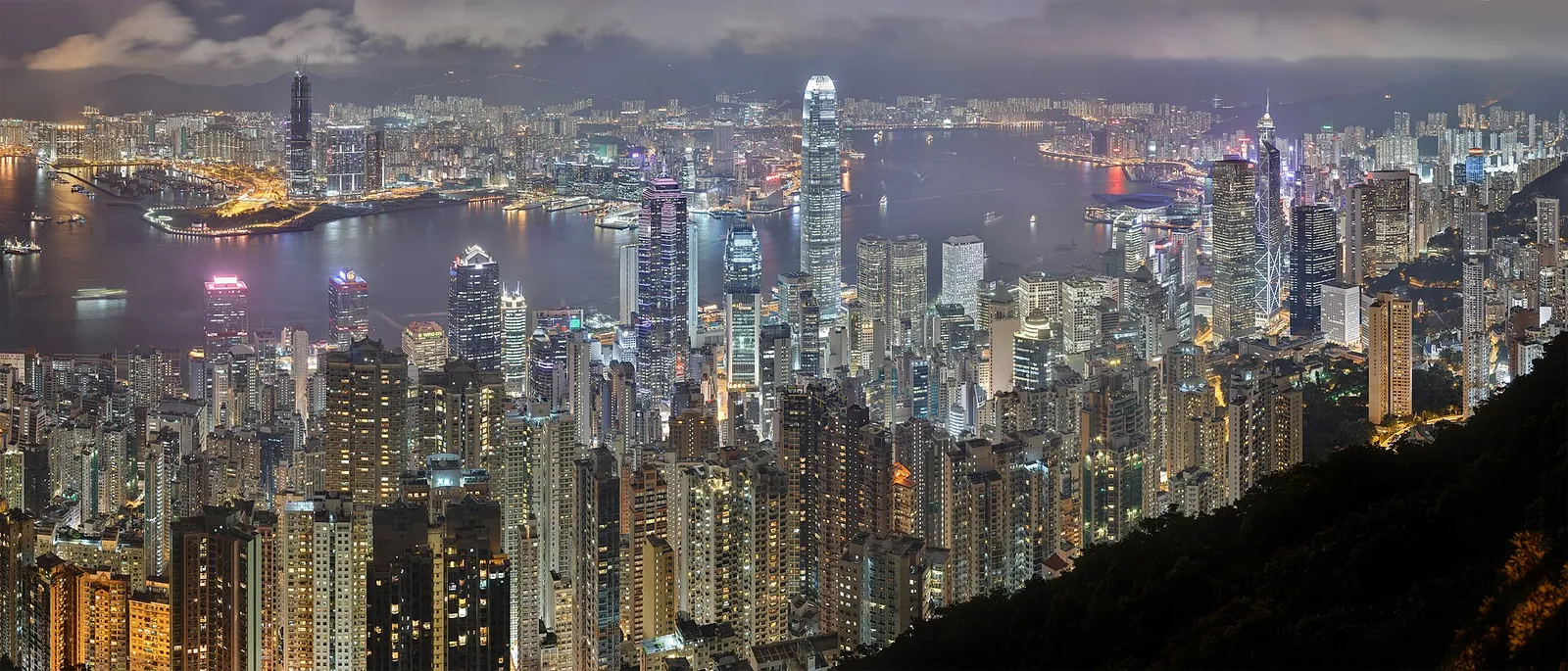 Hong Kong's skyscraper skyline lit up at night around Victoria Harbour