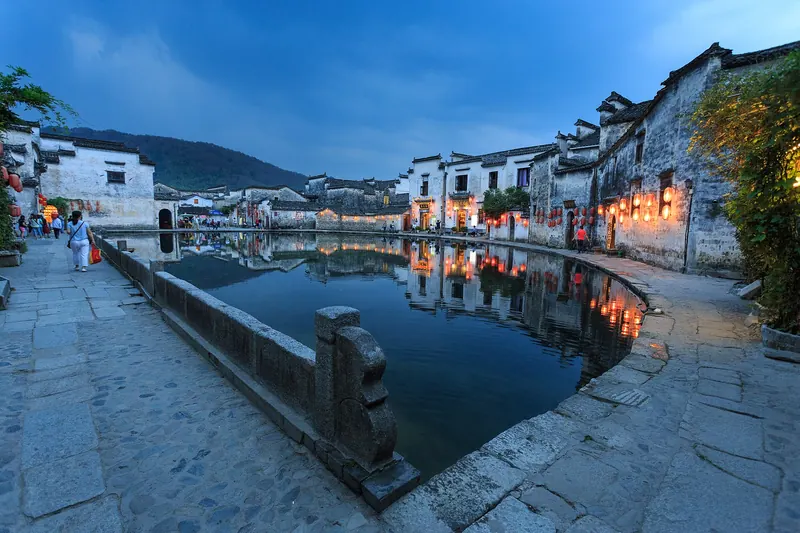 Whitewashed, black-roofed houses reflected in Hongcun's Moon Pond