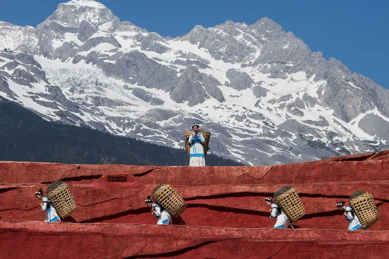 Naxi villagers carrying baskets near Lijiang