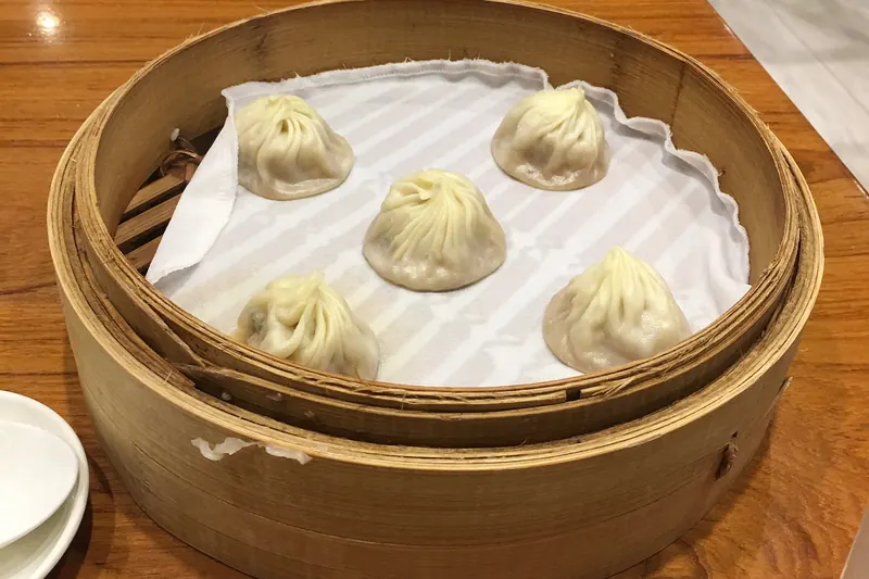 A steamer basket of xiaolongbao soup dumplings