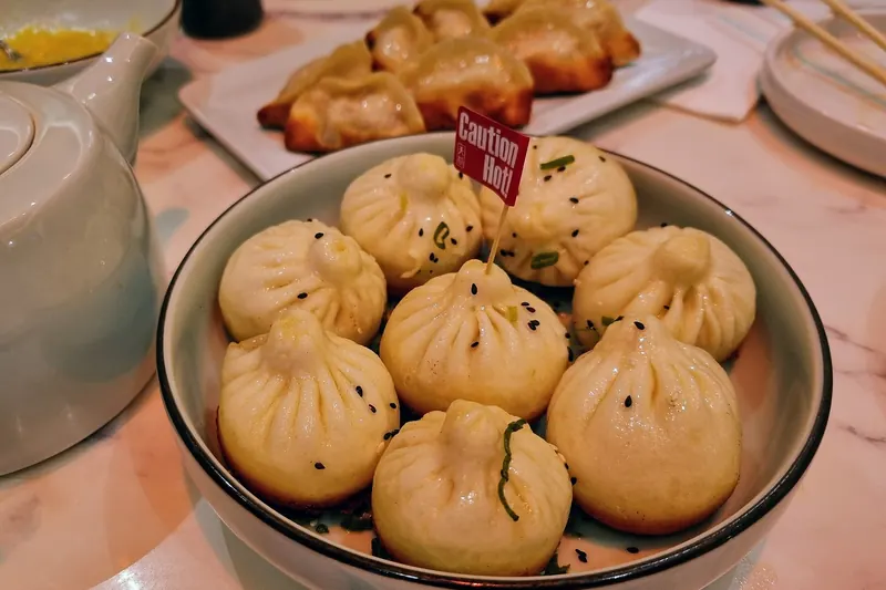 Pan-fried sheng jian bao buns with crisp golden bottoms