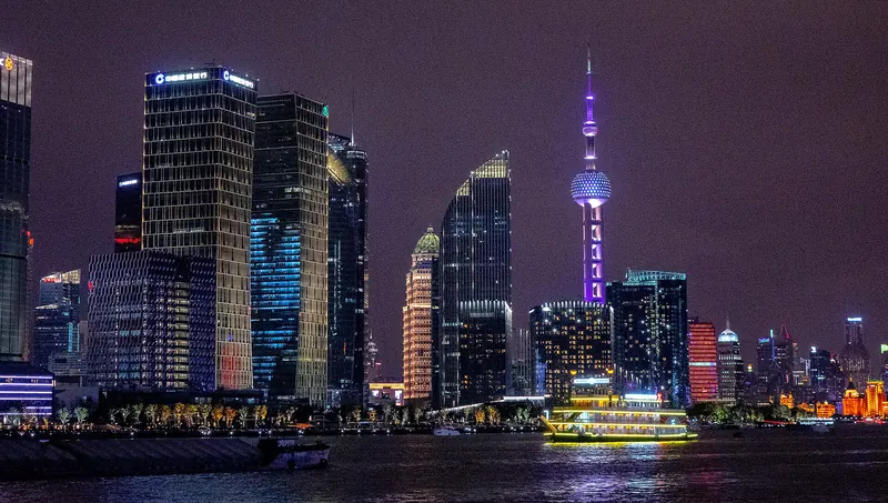 A cruise boat on the Huangpu River with the Shanghai skyline behind