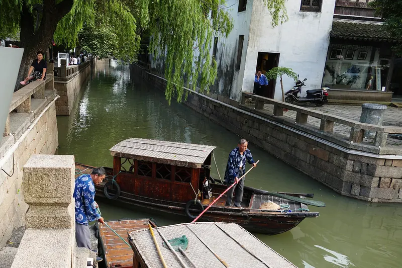 A boat navigating one of Suzhou's historic canals