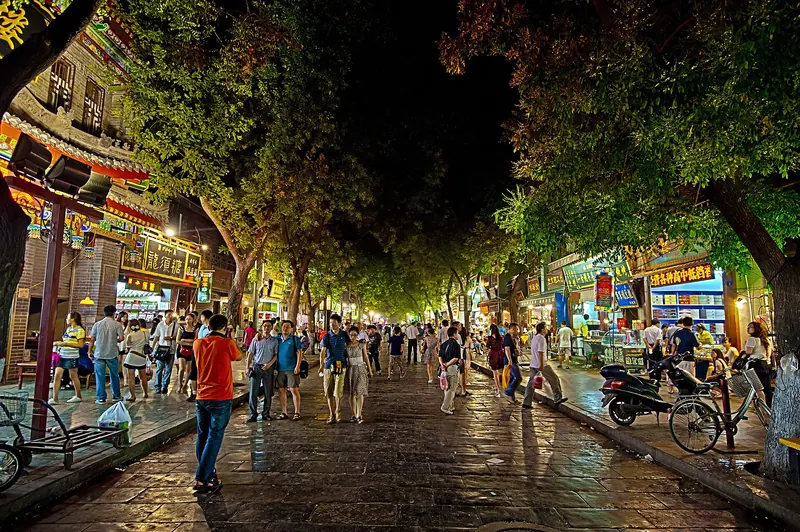 A busy street lined with food stalls in Xi'an's Muslim Quarter