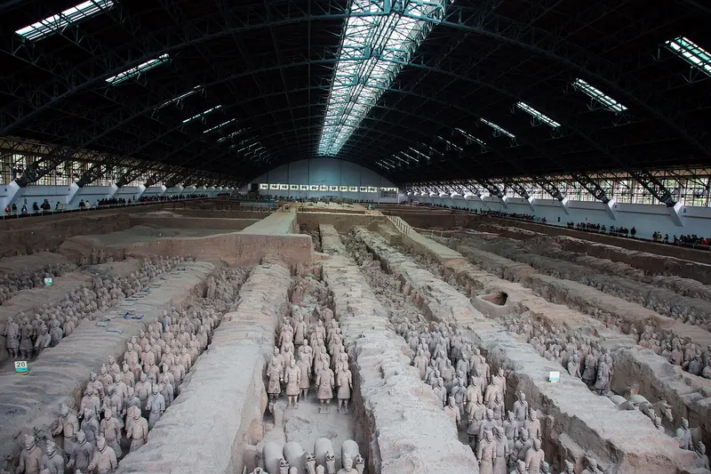 Rows of life-size terracotta soldiers standing in Pit 1 of the Terracotta Army