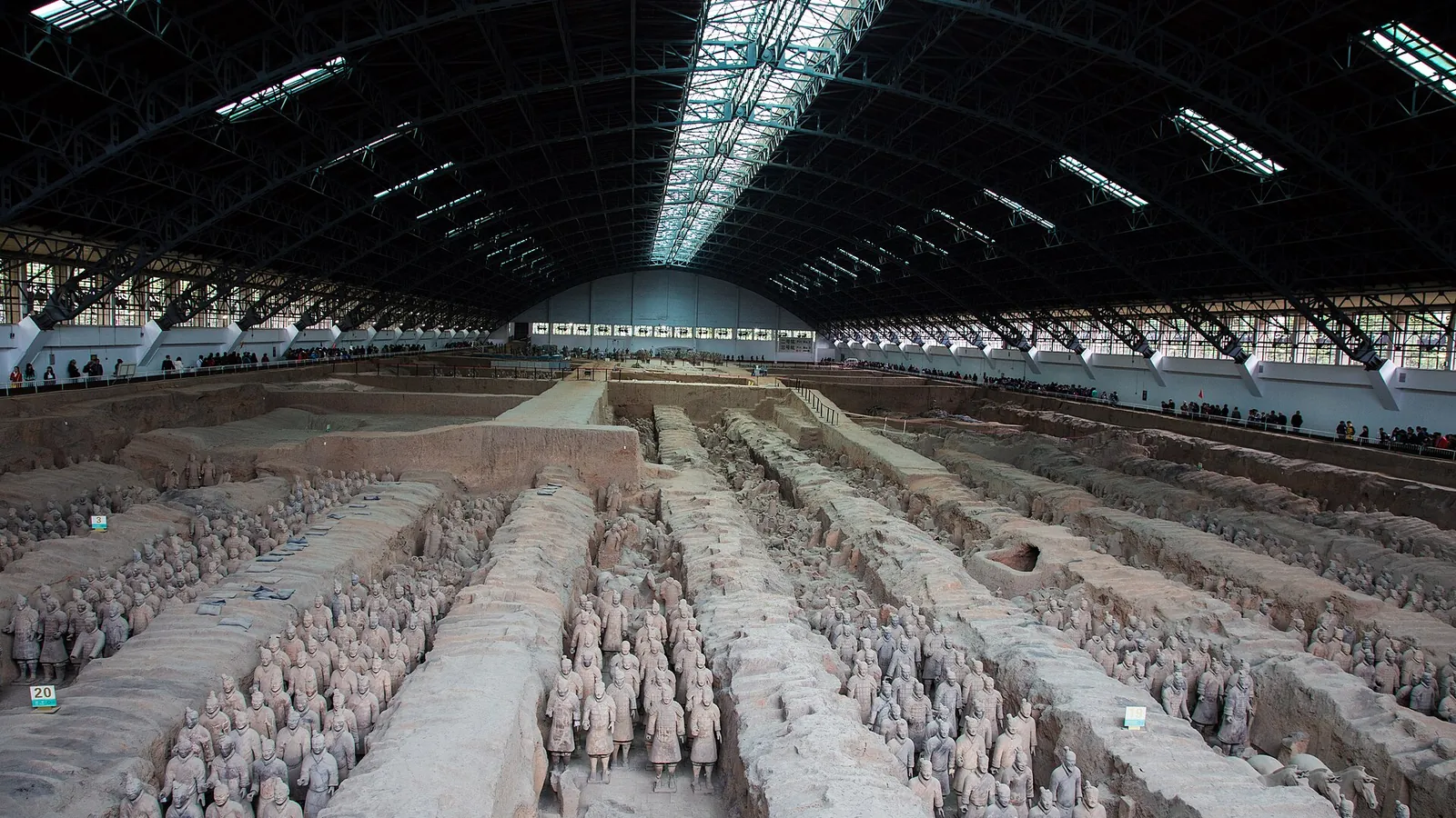 Rows of life-size terracotta soldiers standing in Pit 1 of the Terracotta Army