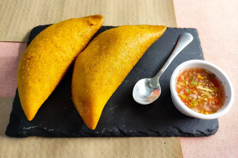 Fried Colombian empanadas served with aji sauce