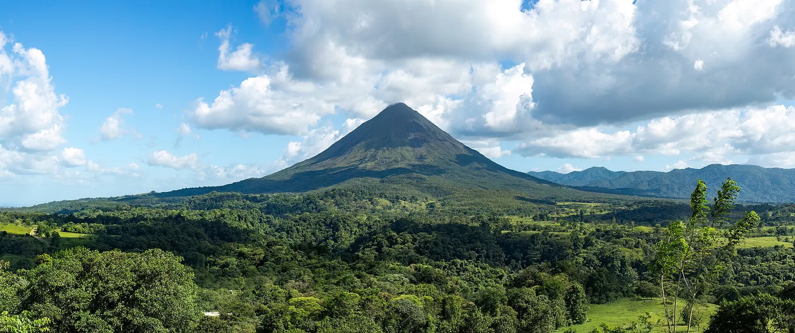 The conical Arenal volcano rising above the rainforest