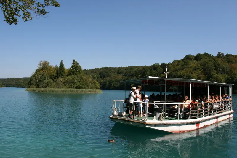 An electric tourist boat crossing Lake Kozjak at Plitvice