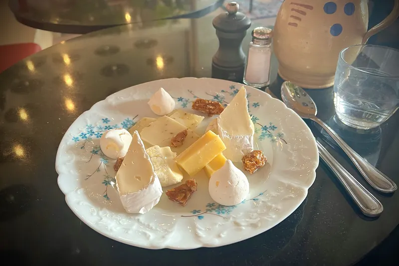 A plate of assorted French cheeses served in a restaurant