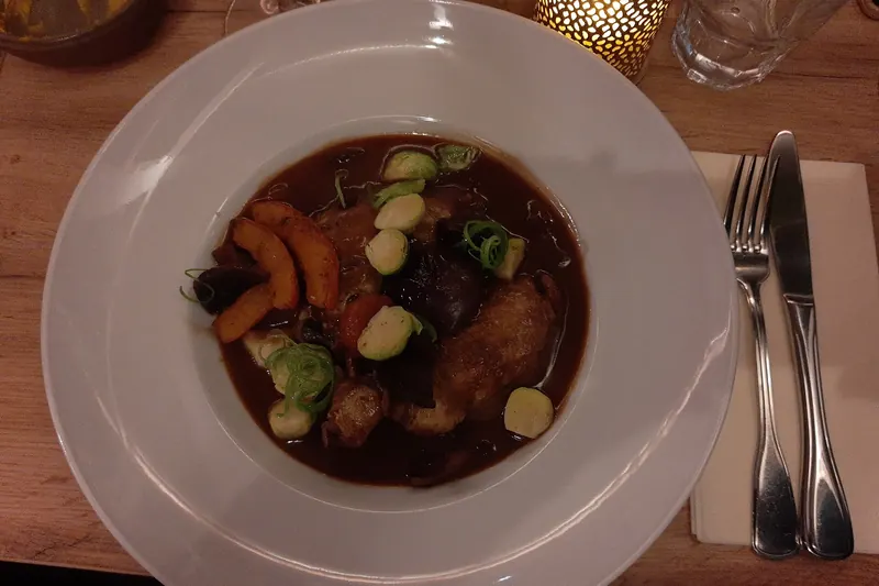 Coq au vin — chicken braised in red wine with lardons and mushrooms