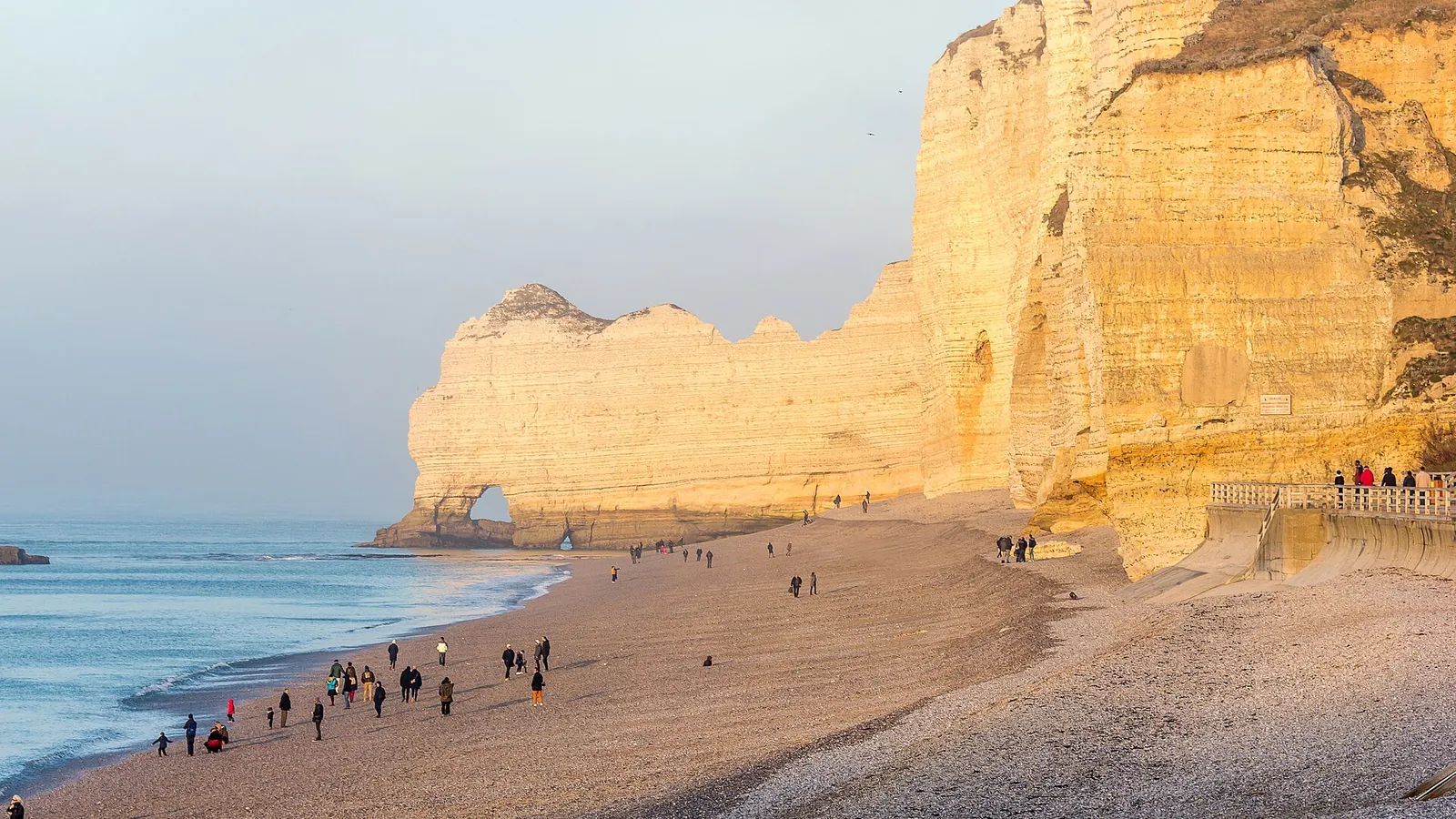 The white chalk arch and needle rock of Étretat rising from the sea in Normandy