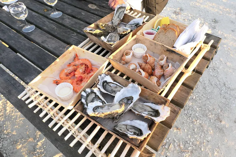A dozen oysters ready to eat at a market counter