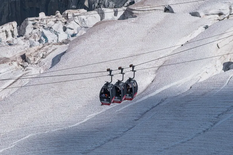 Gondola cars crossing the crevassed glacier below the Aiguille du Midi