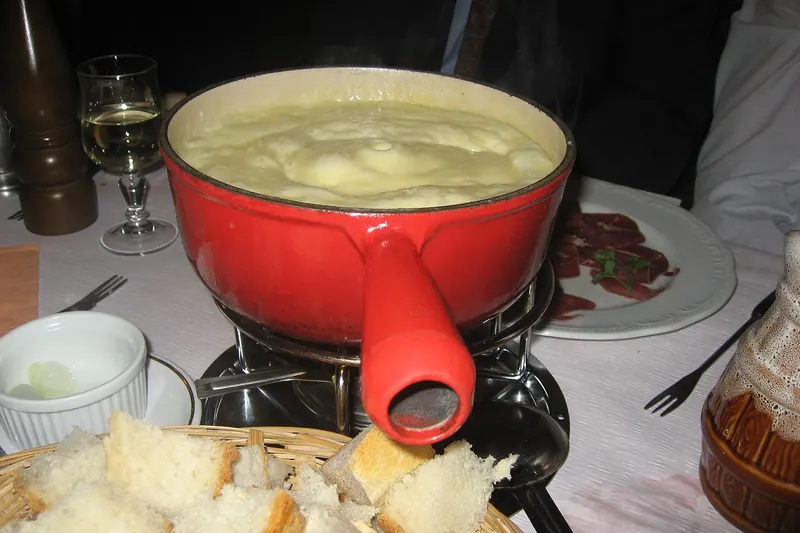 A pot of melted cheese fondue