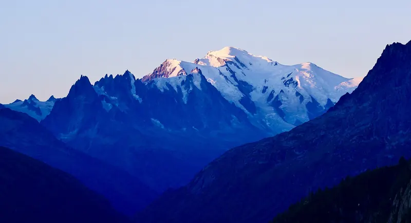 The snow-covered peaks and glaciers of the Mont Blanc massif above the Chamonix valley
