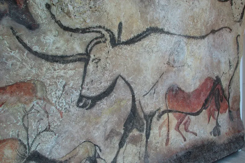 Painted animal figures on the replica cave wall at Lascaux IV