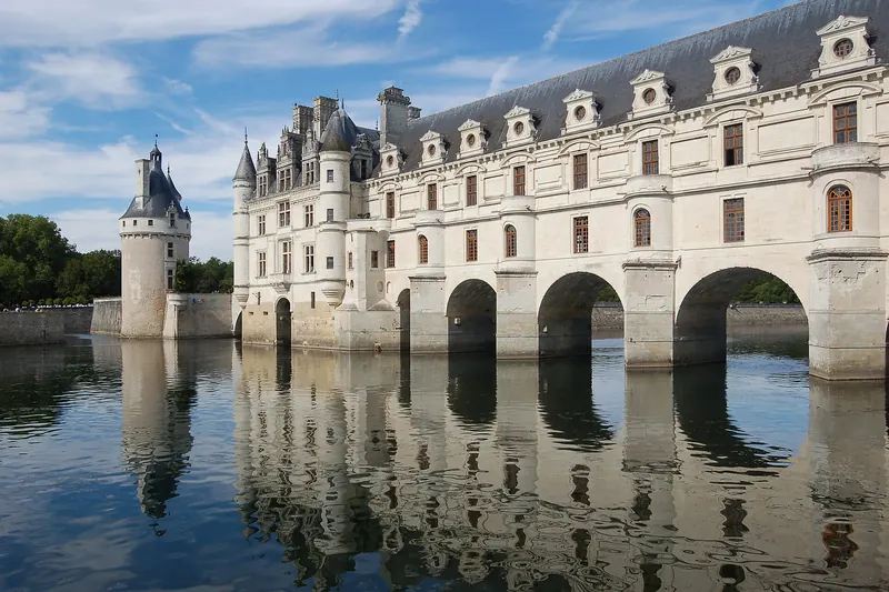 Château de Chenonceau's arched gallery spanning the River Cher, reflected in the water