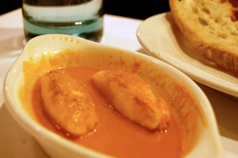 Pike quenelles served in sauce with bread