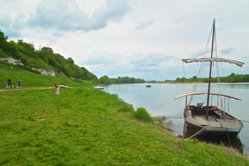 A traditional wooden gabare boat moored on the bank of the Loire