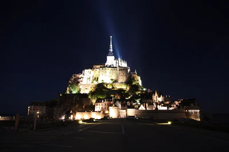 Mont-Saint-Michel floodlit against the night sky