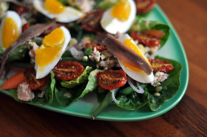 A salade niçoise of tomatoes, egg, olives and anchovies