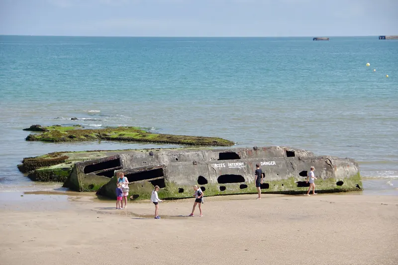 A surviving concrete Mulberry harbour caisson off the beach at Arromanches