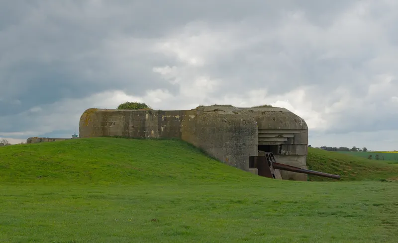 An original German gun still in its casemate at the Longues-sur-Mer battery