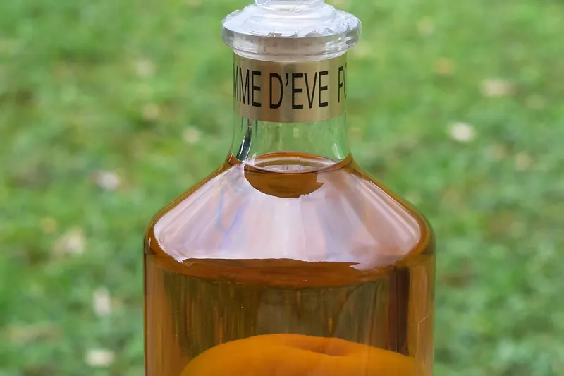A decanter of Calvados with a whole apple grown inside the bottle