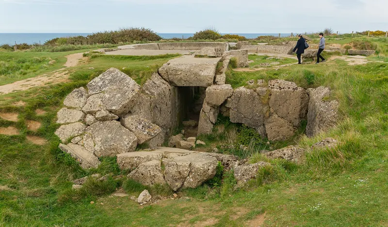 Visitors examining a German bunker at Pointe du Hoc