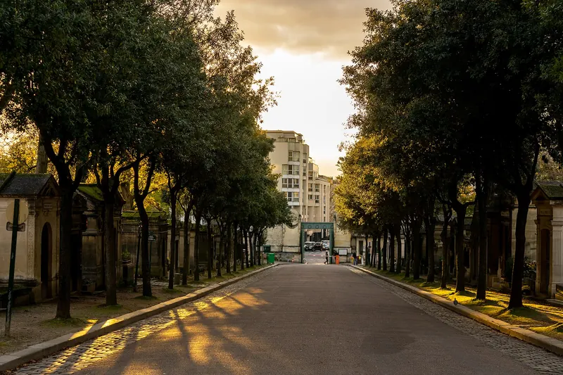 Cobbled avenues and tombs at Père-Lachaise in the golden-hour light