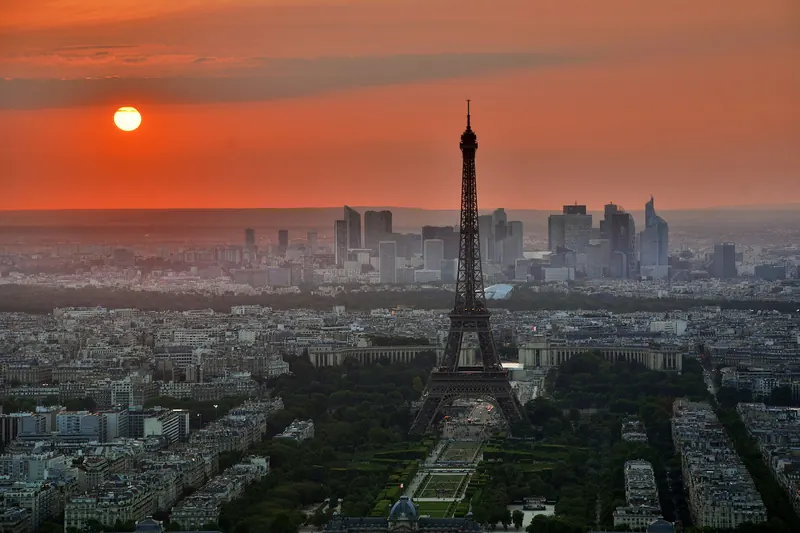The Eiffel Tower rising above the Paris rooftops at sunset